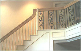 Photo of stair with half wooden balusters and half wrought iron balusters